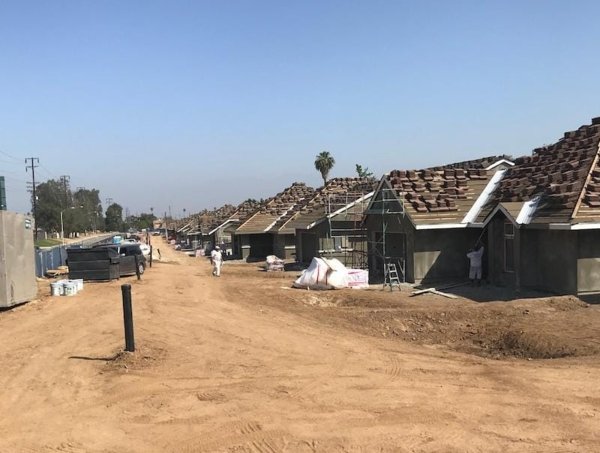 shingles being placed on many of the neighborhood homes