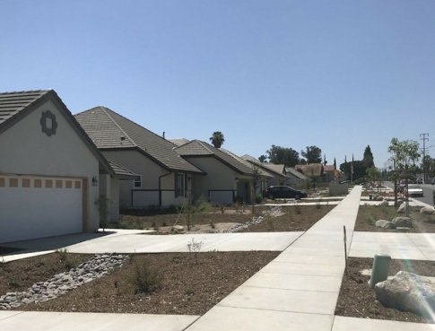 neighborhood with the sidewalks and driveways completed