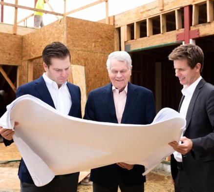 Ayres family looking at construction documents